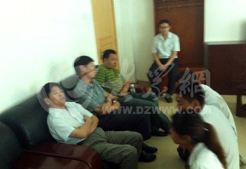 在壽光市人民醫(yī)院接待室，3名死者家屬向院方人員下跪，院方人員表情漠然。