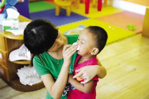 2012年9月3日，浙江一所幼兒園，老師幫孩子擦鼻涕。