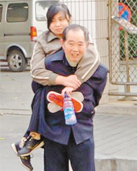 邱世祿背小娟上學。